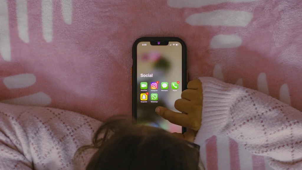 ein kind bedient ein smartphone mit eingegangenen benachrichtigungen